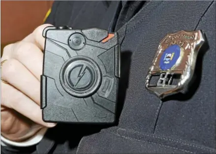  ?? DIGITAL FIRST MEDIA FILE PHOTO ?? Saratoga Springs Police officer Scott Johnson displays a body camera on this Jan. 13file photo from Saratoga Springs, New York. The Winchester Police Department has requested funding for body cameras in next year’s budget.