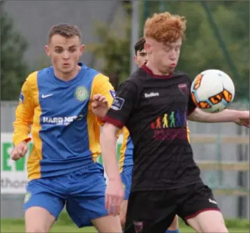  ??  ?? Adam Feeney of Wexford F.C. controls the ball under pressure from Bray’s Gavin Howard.