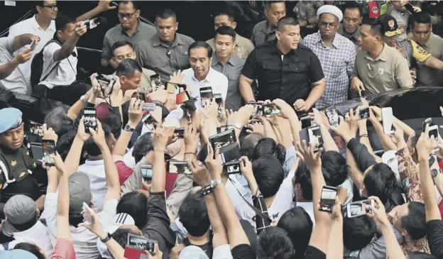  ?? PICTURE; GETTY IMAGES ?? 0 Indonesian President Joko Widodo greets supporters in the capital Jakarta after the country’s general election