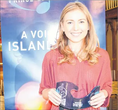  ?? SALLY COLE/THE GUARDIAN ?? Alicia Toner displays her SOCAN Songwriter of the Year Award for her song, “Back to Fine”, which was presented Thursday night at St. Paul’s Church in Charlottet­own at the first of the ticketed shows for 2018 Credit Union Music P.E.I. Week.