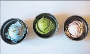  ?? AP PHOTO ?? Three flavors of vegan ice cream (from left) Planet Earth, Matcha Green Tea, and Toasted Coconut Brownie Sundae - are on display at a Van Leeuwen shop in the Brooklyn borough of New York.