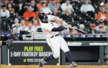  ?? Michael Wyke ?? Astros designated hitter Tyler White hits a home run in the ninth inning to beat the Athletics on Wednesday in Houston.The Associated Press