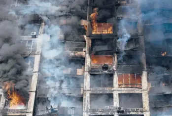  ?? ARIS MESSINIS/GETTY-AFP ?? A fire rages inside a building after an attack by Russian forces Tuesday in a residentia­l area of Kyiv.