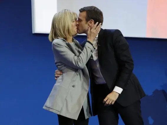  ??  ?? The French presidenti­al candidate shares an onstage kiss with his wife as he prepares to address supporters after winning the first round of the country’s election (EPA)