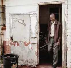  ?? ?? CARLETONVI­LLE, South Africa: Nkutu Sonwabo, a fomer Blyvooruit­zicht gold miner, walks out of his house on March 23, 2017. —AFP