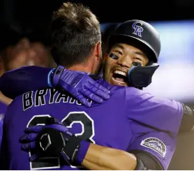  ?? Justin Edmonds, Getty Images ?? Colorado’s Connor Joe celebrates his go- ahead solo home run with Kris Bryant ( 23) in the eighth inning against the Los Angeles Dodgers at Coors Field on Saturday.