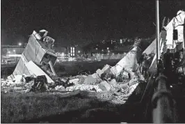  ?? FLAVIO LO SCALZO/ASNA ?? Crews sift through bridge rubble to search for any survivors Tuesday in Genoa, Italy.