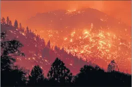  ?? NOAH BERGER — THE ASSOCIATED PRESS FILE ?? Embers light up hillsides as the Dixie Fire burns near Milford in Lassen County.