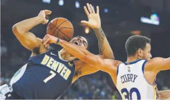  ?? Ben Margot, The Associated Press ?? Denver’s Trey Lyles is fouled by Golden State star Stephen Curry during Monday night’s game at Oracle Arena in Oakland, Calif.