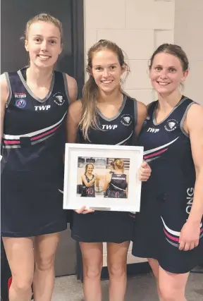  ??  ?? WELL DONE: Geelong Cougar Hannah Kennedy, middle, after her 100th game.