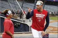  ?? ALEX BRANDON - THE ASSOCIATED PRESS ?? Meyer Cabrera, 12, left, talks with is dad Washington Nationals second baseman Asdrubal Cabrera during batting practice before Game 3of the baseball World Series against the Houston Astros Friday, Oct. 25, 2019, in Washington.