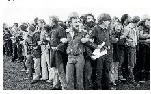  ?? STUFF ?? Protesters linked arms and chanted, ‘‘The whole world’s watching,’’ during the tense standoff on the Rugby Park pitch.