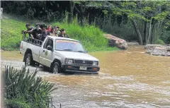  ??  ?? ABOVE A shuttle truck crossing a stream to the flower fields in Sai Thong National Park.