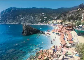  ??  ?? a beach in the Cinque terre on the Italian riviera, which has introduced fines for tourists who wear the wrong footwear. — dpa