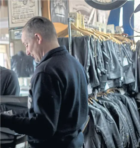  ??  ?? MAIN PHOTO Bennie Goodson, right, explains the details of a new jacket to Chris Page, a Nike executive, at Langlitz Leathers.