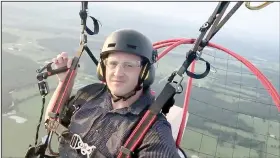  ?? Courtesy photo ?? Jeff O’Brien, a captain with Prairie Grove Police Department, paraglides in the air above Lincoln.