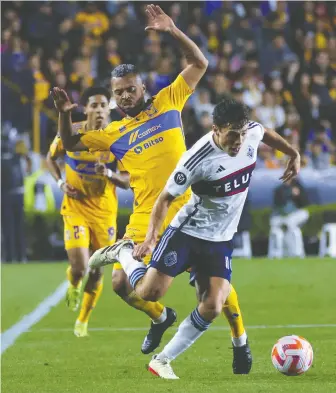  ?? JORGE MENDOZA/THE CANADIAN PRESS/AP ?? Rafael Carioca of Mexico's Tigres, left, and Sebastian Berhalter of the Whitecaps clash in Mexico, on Feb. 14. A shorter pre-season meant the Caps hit the field sooner than usual.