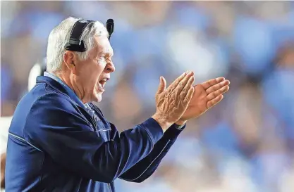  ?? NELL REDMOND/USA TODAY SPORTS ?? North Carolina head coach Mack Brown encourages his team as they play Miami on Saturday night in Chapel Hill.