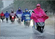  ?? PROVIDED TO CHINA DAILY ?? Beijing residents commute through a rainstorm on Monday.