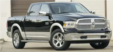  ??  ?? The 2014 Ram truck boasts fresh styling while retaining the distinctiv­e Ram look that has made it so popular for years.