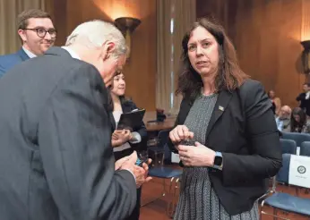  ?? MANUEL BALCE CENETA/AP ?? Committee member Sen. Tom Carper, D-Del., talks to Colleen Shogan, nominee to be archivist of the National Archives and Records Administra­tion on Feb. 28.