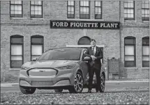  ?? RYAN GARZA/DETROIT FREE PRESS/TNS ?? In this photo from Jan. 14, Ford Motor Co. CEO Jim Farley stands with a 2021 Mustang Mach-E 4X model outside the Ford Piquette Avenue Plant in Detroit.
