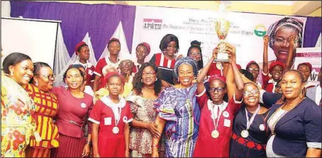  ??  ?? Former Vice-President, Nigeria Society of Engineers (NSE), Mrs. Mayen Adetiba with teachers and students of Ikeja Junior High School raising the trophy presented to the overall winning school, at the 2019 Mayen Adetiba Technical Boot Camp for Girls award and prize-giving ceremony held in Lagos ... recently