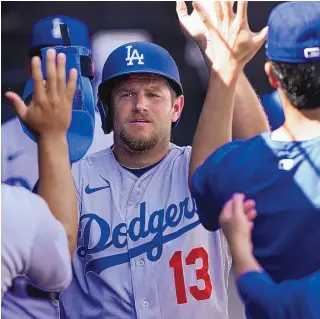  ?? CHARLES REX ARBOGAST/ASSOCIATED PRESS ?? The Los Angeles Dodgers’ Max Muncy celebrates his home run in the dugout during Thursday’s game against the Chicago White Sox in Chicago.