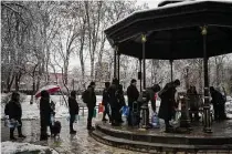  ?? Evgeniy Maloletka/associated Press ?? Residents wait in line to collect water Thursday in Kyiv, Ukraine, after new Russian missile strikes a day earlier.