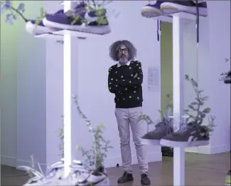  ?? (Photos Jean-François Ottonello) ?? Michel Blazy devant cette collection de chaussures garnies de plantes, présentée lors de la dernière Biennale de Venise.