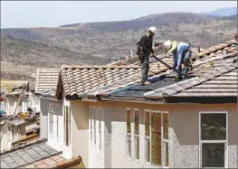  ?? Hayne Palmour IV San Diego Union-Tribune ?? INSTEAD of being credited at the retail rate of electricit­y, customers will be paid at the “actual avoided cost.” Above, panels are installed in Santee, Calif., in 2018.