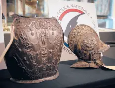  ?? THOMAS SAMSON/GETTY-AFP ?? A breastplat­e and ceremonial helmet stolen from the Louvre 38 years ago have been found.