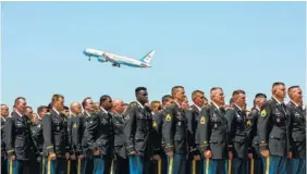  ?? PHOTO BY CAITLIN O’HARA/THE NEW YORK TIMES ?? Members of the Arizona Air National Guard stand in formation as the plane with Sen. John McCain’s remains departs from the 161st Air Refueling Wing at Goldwater Air National Guard Base in Phoenix on Thursday.