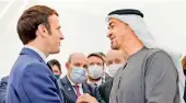  ?? — AFP ?? French President Emmanuel Macron (left) is greeted by Abu Dhabi’s Crown Prince Mohammed bin Zayed alNahyan during his tour of the French pavillion at the Dubai Expo on the first day of his Gulf tour on Friday.