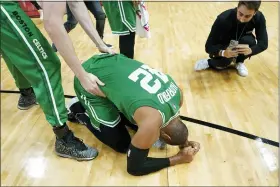  ?? LYNNE SLADKY — THE ASSOCIATED PRESS ?? Boston Celtics center Al Horford (42) falls to his knees after winning Game 7of the NBA basketball Eastern Conference finals playoff series against the Miami Heat, Sunday in Miami.