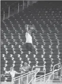  ?? ASSOCIATED PRESS FILE PHOTO ?? A vendor walks through a section of mostly empty seats during a game at Marlins Park stadium in Miami in June.