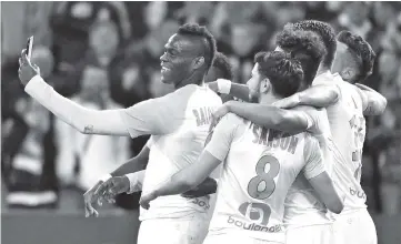  ??  ?? Marseille’s Italian forward Mario Balotelli (L) takes a selfie with teammates after scoring during the French L1 football match between Olympique de Marseille and AS Saint-Etienne at the Velodrome Stadium in Marseille, southern France. - AFP photo