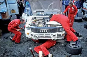  ?? Photo: Graham Rood ?? All hands on deck as David Lewellin and Phil Short’s A2 quattro receives attention on the way to a 4th place finish on the 1985 Ulster Rally.