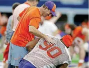  ?? [AP PHOTO] ?? Clemson coach Dabo Swinney greets defensive tackle Dexter Lawrence (90) during practice Monday at AT&amp;T Stadium in Arlington, Texas.