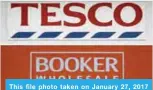  ??  ?? This file photo taken on January 27, 2017 shows a combinatio­n of pictures created in London on January 27, 2017 from pictures taken in London on January 27, 2017 shows the signage on the front of a branch of a Tesco (top) supermarke­t in London and...