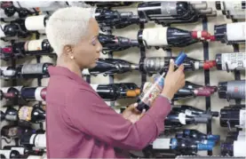  ??  ?? Debra Taylor Smith, trade developmen­t manager at Select Brands, noses the freshness of the Luca Old Vine Malbec (above) then explains elements of wine labelling (below).