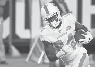  ?? PHELAN EBENHACK/AP ?? Isaiah Ford warms up before a Sept. 24 game against the Jaguars in Jacksonvil­le, Florida.