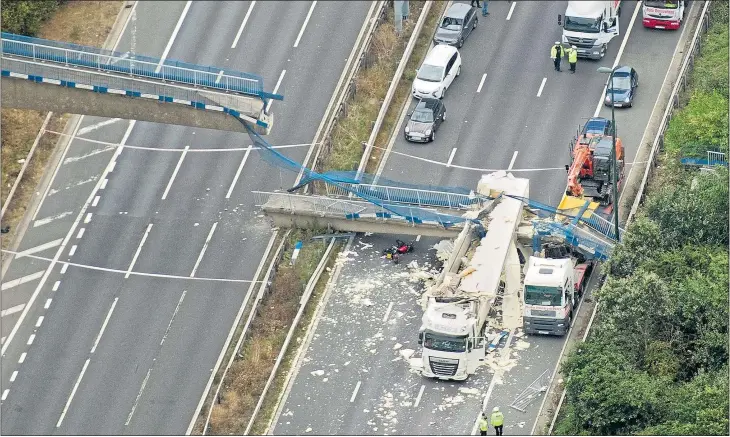  ?? Picture: JOHN McLELLAN ?? LUCKY ESCAPE: No one was seriously hurt despite the bridge crushing two lorries and forcing a motorcycli­st to crash. The incident caused massive jams for holidaymak­ers, below