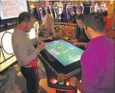  ?? Joe Janet ?? A VIDEO POKER machine that can accommodat­e four players is seen on the f loor at Harrah’s Resort Southern California. The Gamlit Gaming machine fuses popular video game technology with wagering.