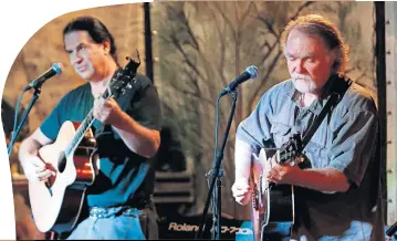  ?? [OKLAHOMAN ARCHIVES] ?? Greg Jacobs, right, and Gene Williams play July 11, 2013, on the Brickstree­t Stage during the 2013 Woody Guthrie Folk Festival in Okemah.