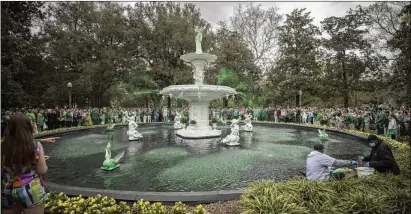  ?? PHOTOS BY STEPHEN B. MORTON FOR THE AJC ?? City workers dye Savannah’s Forsyth Fountain, one of several transforme­d during the Greening of the Fountain event March 8, which this year marks the 200th anniversar­y of the Savannah St. Patrick’s Day Parade.