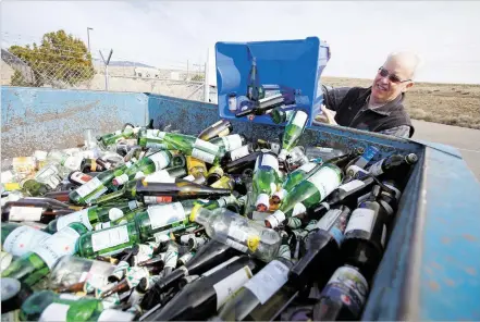  ?? LUIS SÁNCHEZ SATURNO/THE NEW MEXICAN ?? Las Campanas resident Mark Moran drops off his recycled glass Friday at the Buckman Road Recycling & Transfer Station. Crews will begin delivering 64-gallon recycling carts this month to tens of thousands of homes in the city of Santa Fe, replacing the...