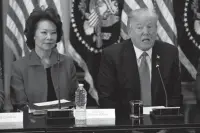  ?? Associated Press ?? n Transporta­tion Secretary Elaine Chao listens Tuesday as President Donald Trump speaks during a meeting with business leaders in the State Department Library of the Eisenhower Executive Office Building.