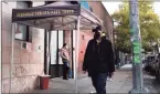  ?? Getty Images ?? People walk past an East Harlem health clinic that offers services to drug users in New York City.