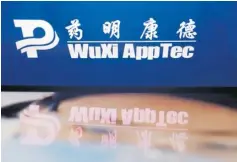  ?? Picture: REUTERS ?? The logo of Chinese drug research and developmen­t group WuXi AppTec is displayed alongside its company website.